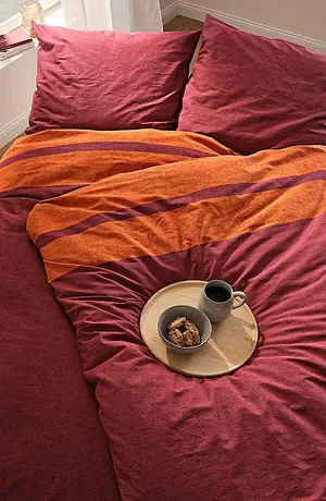 Parure de lit douillette dans des teintes automnales chaudes pour les nuits fraîches.