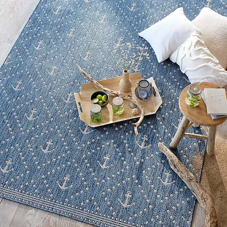 Tapis bleu chaleureux avec des touches de blanc invite à la détente. 